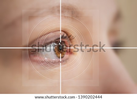eye surgery concept, close up of female amber eye with digital augmentation Royalty-Free Stock Photo #1390202444