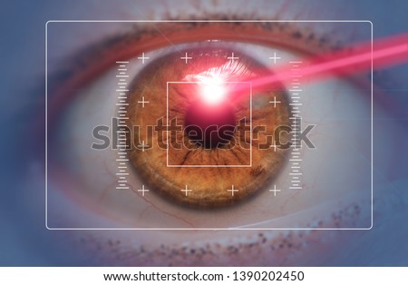 laser eye surgery concept, red laser beam hitting amber eyes Royalty-Free Stock Photo #1390202450