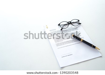 White table with paper contract detail and empty space to sign authorized signature, props with glasses and ink pen, copy space on the left Royalty-Free Stock Photo #1390203548