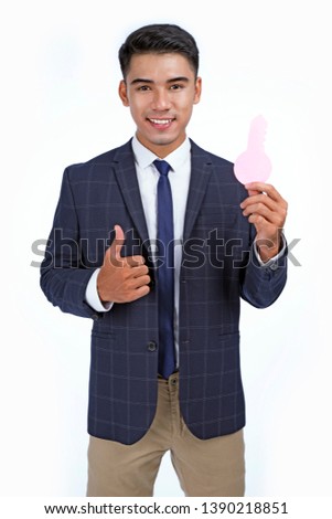Asian handsome young business man holding concept paper key, isolated on white background, with copy space