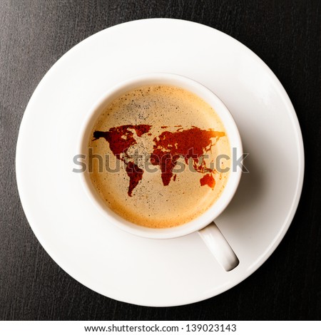 cup of fresh espresso on table, view from above. Earth silhouette is from visibleearth.nasa.gov Royalty-Free Stock Photo #139023143