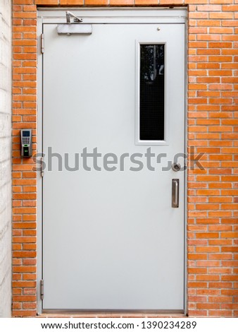 Electric door with digital lock on brick wall background vertical style.
