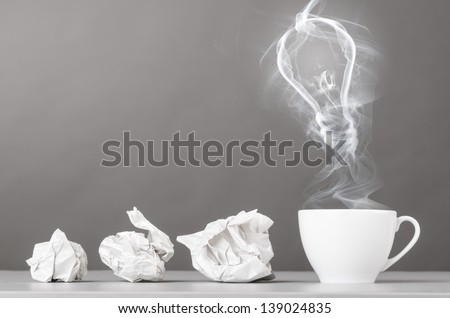 idea birth. crumpled wads and bulb silhouette on gray Royalty-Free Stock Photo #139024835