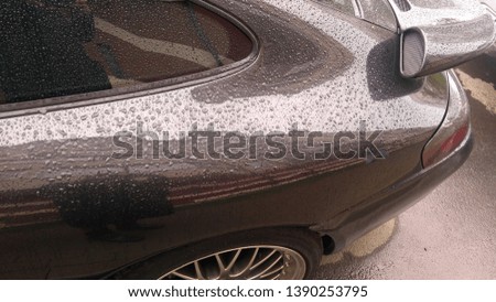 Surface of a car under rain