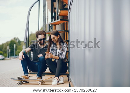 The guy and the girl with a skateboard. Couple with the phone