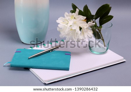Office supplies in composition with a beautiful white flower
