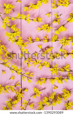 Pink wooden pattern decorated with yellow flowers, top view