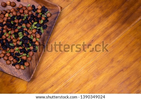 Assorted nuts in wooden bowl on empty table. Healthy snack on wooden background. Rustic breakfast top view photo. Natural food banner template. Mixed seeds and nuts served for food. Protein diet meal