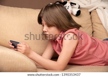 Teen girl looking to the her smartphone