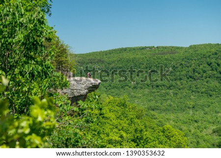 Tourist visitors couple taking pictures at Whitaker Point rock cliff hiking trail, landscape view, Ozark mountains, nwa northwest arkansas Royalty-Free Stock Photo #1390353632