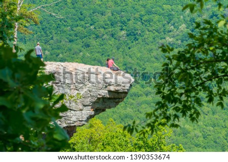 Tourist visitors couple taking pictures at Whitaker Point rock cliff hiking trail, landscape view, Ozark mountains, nwa northwest arkansas Royalty-Free Stock Photo #1390353674
