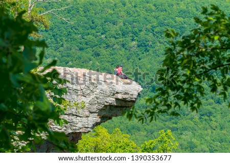 Tourist visitors couple taking pictures at Whitaker Point rock cliff hiking trail, landscape view, Ozark mountains, nwa northwest arkansas Royalty-Free Stock Photo #1390353677