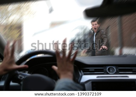 A young male pedestrian has an accident with a car Royalty-Free Stock Photo #1390372109