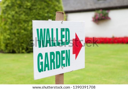 A sign to a walled garden