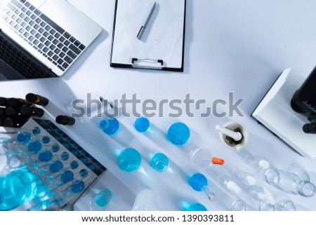 top view desktop of laboratory with laptop and glassware