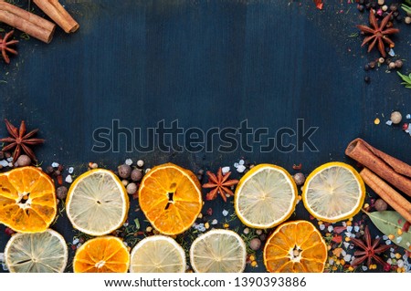 set of dried fruits and candied fruit for mulled wine with lemon, orange on blue wooden background
