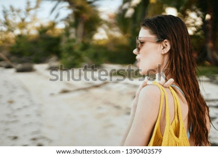 woman in glasses looks at the ocean                               
