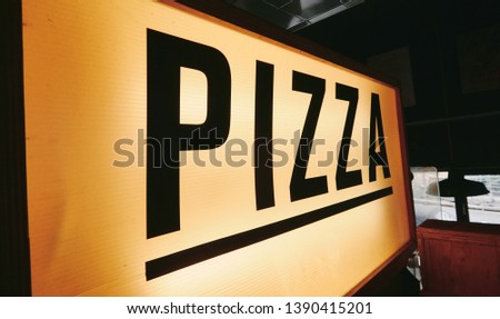 A trendy iconic cinematic typist font new york pizza sign inside a retro vintage hipster pizza diner in a city. Pop up eatery style pizza counter.                   