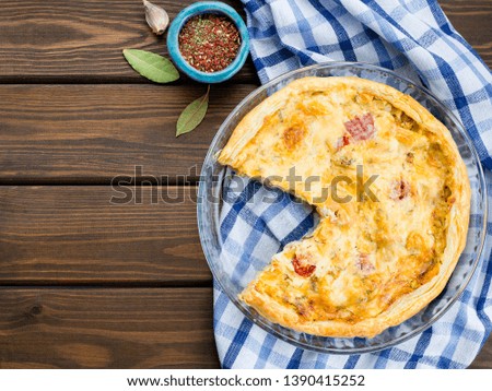 Rustic large tart with cloth on a wooden table, view from above, close-up