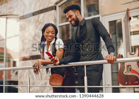 A stylish and beautiful dark-skinned couple in a city