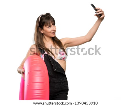 Young woman in bikini making a selfie over isolated white background