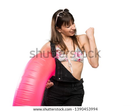 Young woman in bikini celebrating a victory over isolated white background