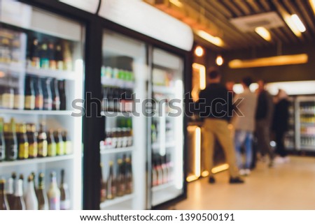 Background Blurred Defocused Beers are cooling in fridge, freezer or refrigerator shelf. Defocused Blurry Night life, Night Club, Bar, Pub, Store or Grocery Background concept image. Royalty-Free Stock Photo #1390500191