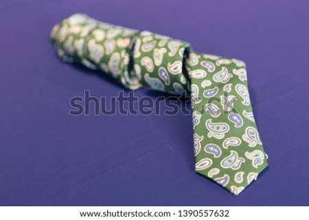 Necktie resting on a blue cloth