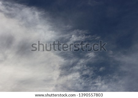 Beautiful clouds background blue sky the sun's rays slightly illuminate their fluffy edges gusts of spread them around the edges of the world