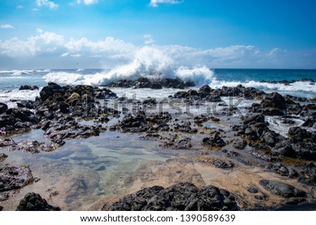 Large wave crashing into rocks