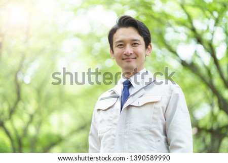 portrait of young asian engineer on green background