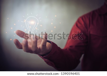 man holding icon light bulb,idea concept,,Presenting new ideas.