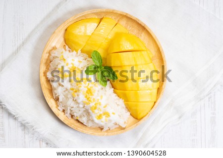 fresh ripe mango and sticky rice with coconut milk, authentic Thai dessert Royalty-Free Stock Photo #1390604528
