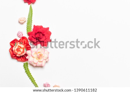 Frame made of rose flowers on white background. Top view with copy space. Flat lay design concept.