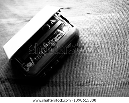 old fashioned music cassette and walkman player in black and white shot
