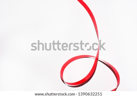 Red curly ribbon isolated on white background.
