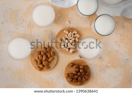 assorted nuts such as almond, cashew, hazelnut and milk in a glass bottle, healthy food