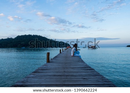 Traveler woman is relaxing on wood bridge in beautiful island, koh kood island, Trat Thailand.
