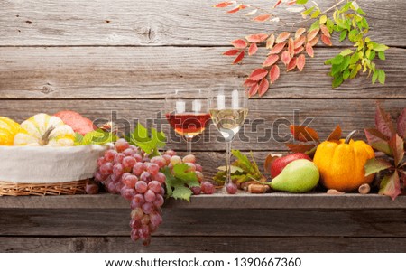 Autumn still life with pumpkins, apples, pears, grapes and colorful leaves. With space for your text