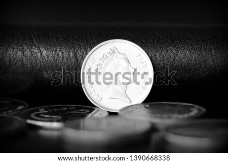 Five fijian cents on a dark background close up. Black and white