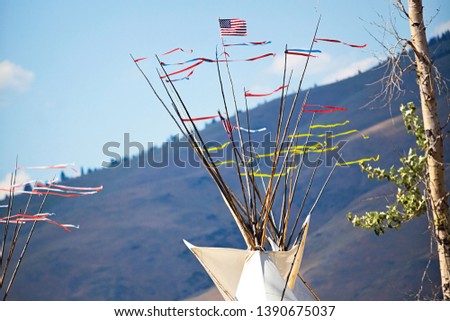 Teepee Poles with Flags Yellow and Red