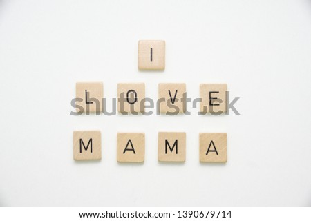 Mother's day greeting "I LOVE MAMA" spelled out in wooden tiles