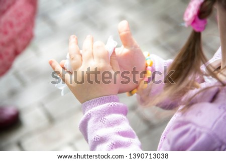 baby s palm with a damp napkin, child cares for purity. Photo of children's palms.