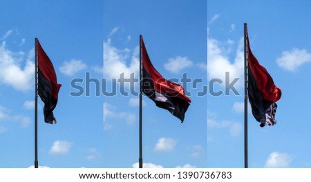 Set of three Right Sector flags isolated on blue sky background. Silk black and red flags on a flagpole flying in the wind in the air