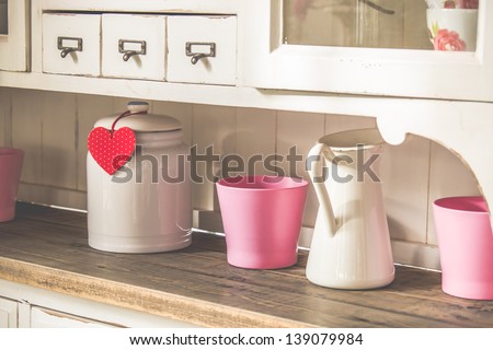 vintage cupboard with jars and heart shaped decorative sign