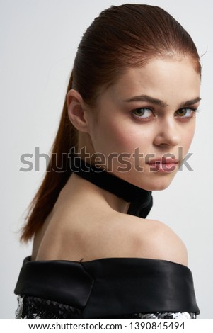 Gorgeous woman in a brilliant jacket tie butterfly on her neck bare shoulders                     