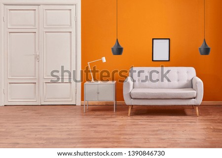Orange living room interior, grey sofa and white door concept.
