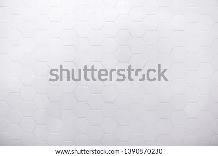 real photo of white hexagonal tiles wall  of the bathroom