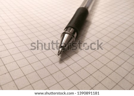 pen with blue paste on a white notepad in the section