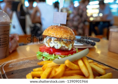 Delicious fresh homemade burger on a wooden table, close-up shooting,Space for text or design